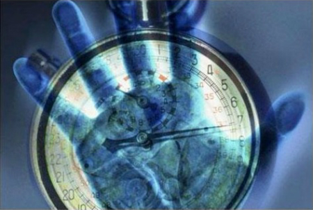 Graphic image of a clock with a hand holding it